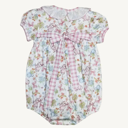 Baby romper with floral and checkered design on a white background
