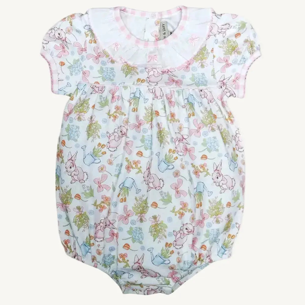 Baby romper with colorful bunny and flower pattern on a white background