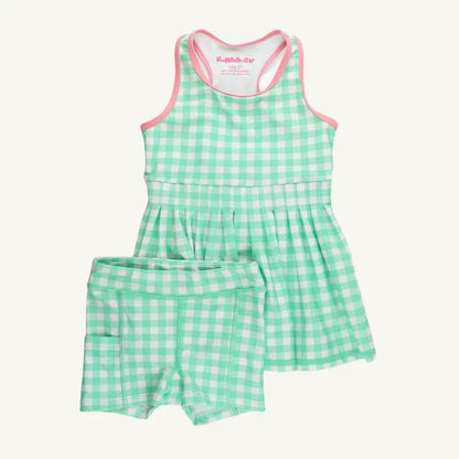 Green and white checkered romper with pink trim on a white background