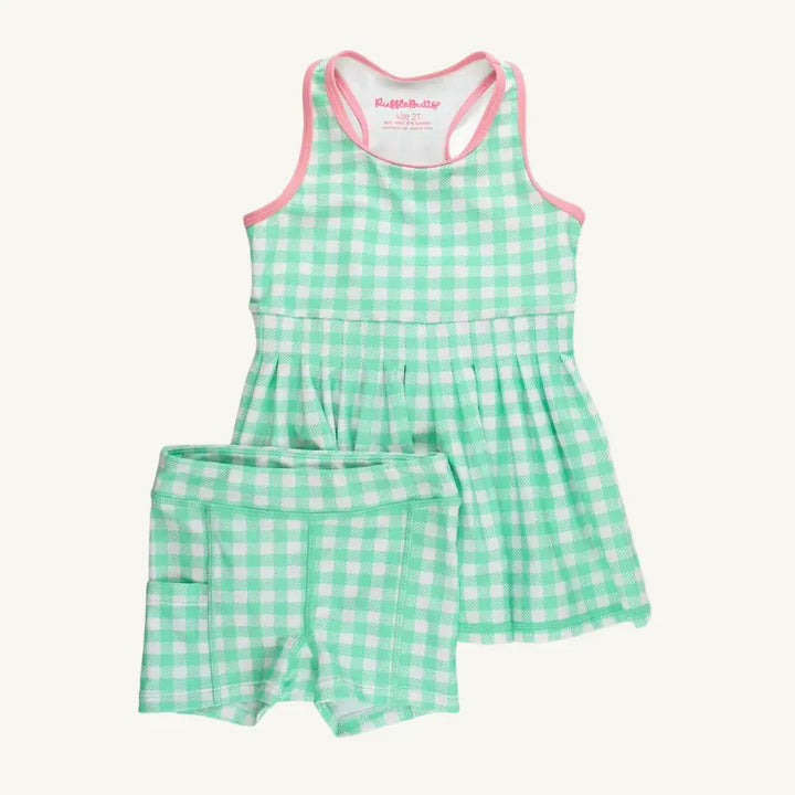 Green and white checkered romper with pink trim on a white background