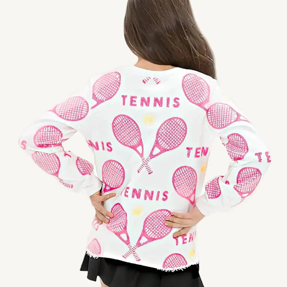 A pink sequin sweatshirt with tennis rackets and balls and a white background.