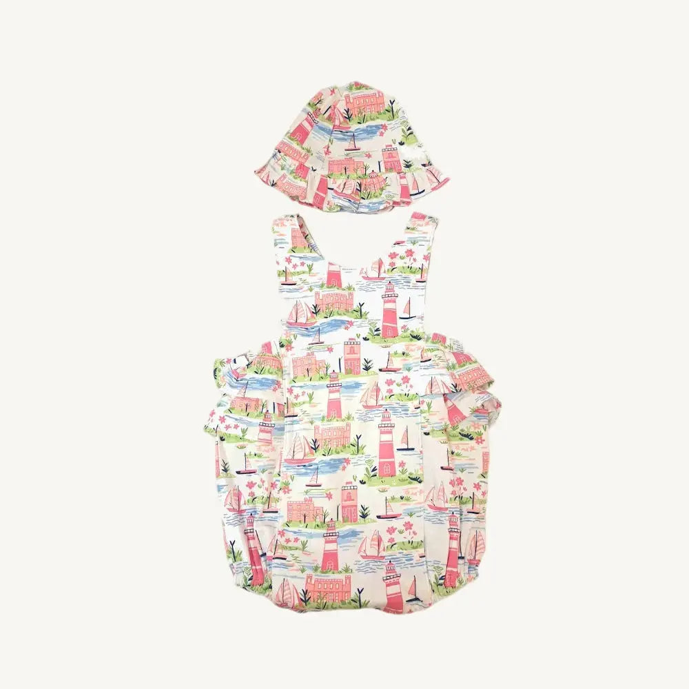 Children's swimsuit set with hat featuring a beach theme on a white background